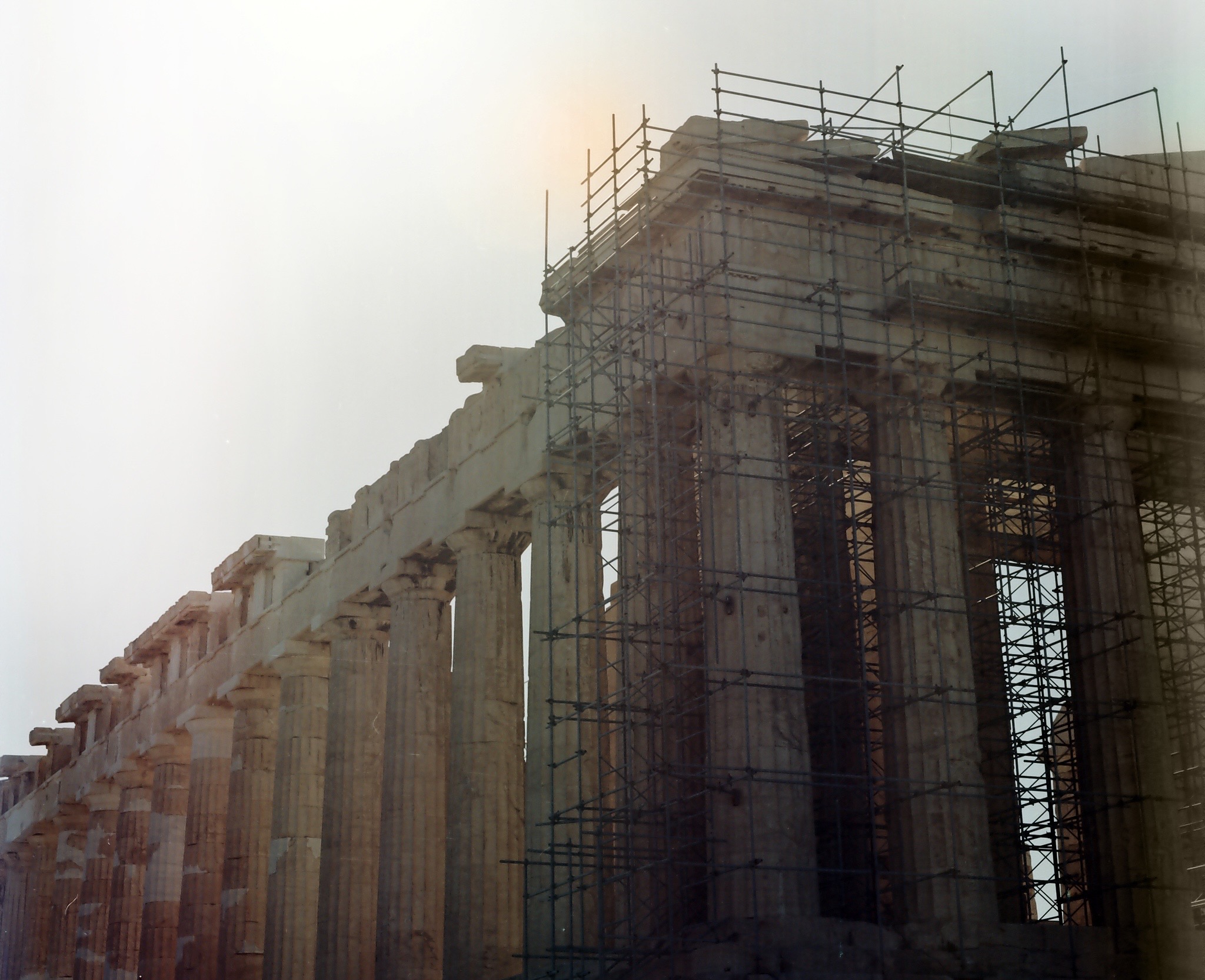 Sunlit stone columns surrounded by scaffolding